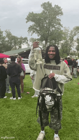 Man Wearing Cactus Valley Shirt Holding Bottle GIF