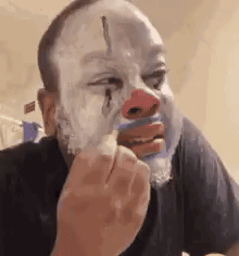 Man Wearing Clown Mask Shaving