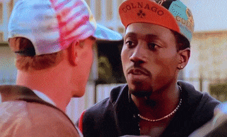 Man Wearing Colnago Hat Looks At Another
