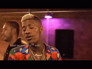 Man Wearing Colorful Gucci Shirt and Necklace