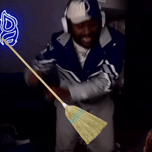 Man Wearing Colts Hat Holding Broom