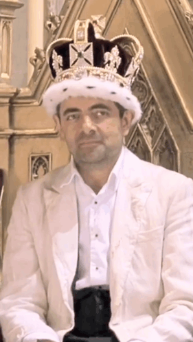 Man Wearing Crown and White Suit