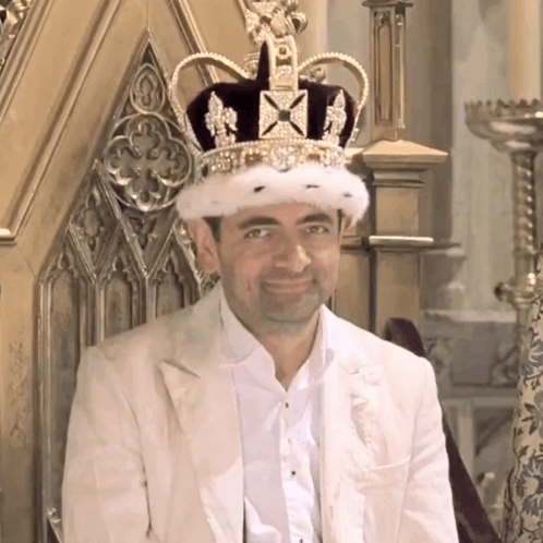 Man Wearing Crown Sitting On Throne Smiling GIF