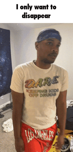Man Wearing Dare Shirt and Red Shorts