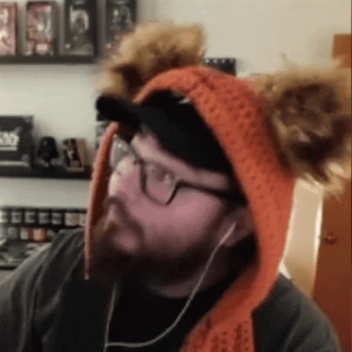 Man Wearing Eared Hat and Headphones