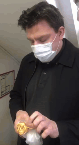 Man Wearing Face Mask Holding Donut GIF