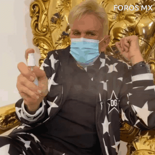 Man Wearing Face Mask Holding Spray Bottle