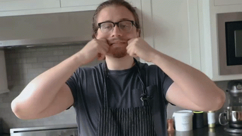 Man Wearing Glasses and Apron Making Face