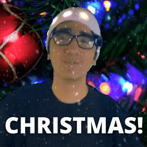 Man Wearing Glasses and Beanie Standing in Front of Christmas Tree