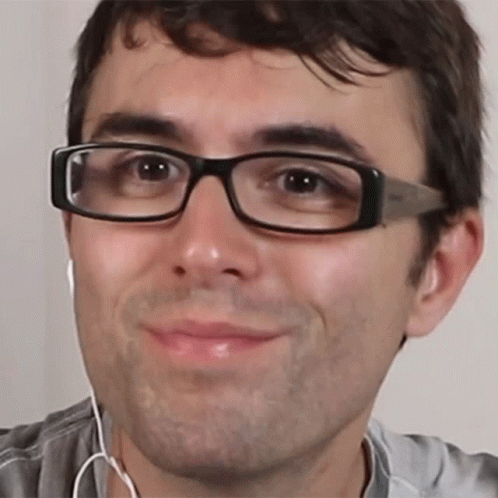 Man Wearing Glasses and Earbuds Smiling