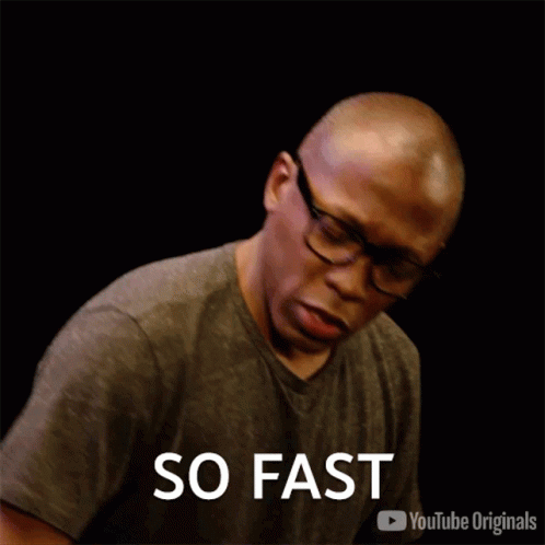 Man Wearing Glasses and Gray Shirt Saying Fast