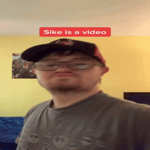 Man Wearing Glasses and Hat Saying Sike Is a Video