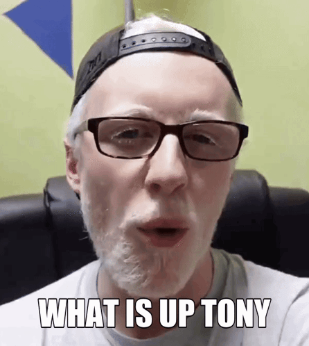 Man Wearing Glasses and Hat Saying What Is Up Tony