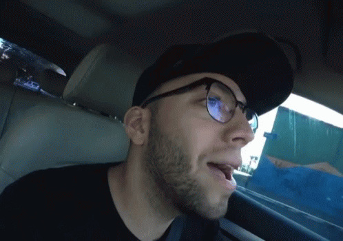 Man Wearing Glasses and Hat Yawning