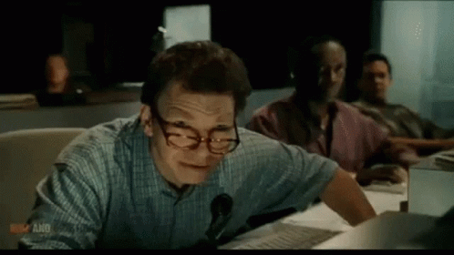 Man Wearing Glasses and Headphones at Desk
