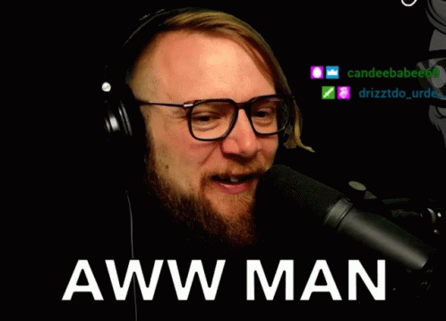 Man Wearing Glasses and Headphones Talking Into Microphone