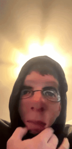 Man Wearing Glasses and Hoodie Making Face