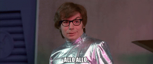 Man Wearing Glasses and Metallic Outfit Says Allo Allo