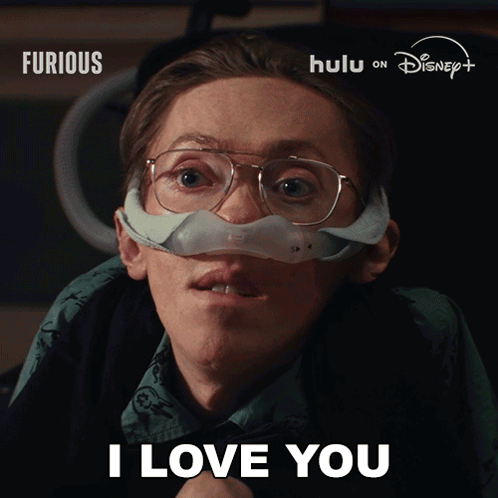 Man Wearing Glasses and Nose Mask Says I Love You