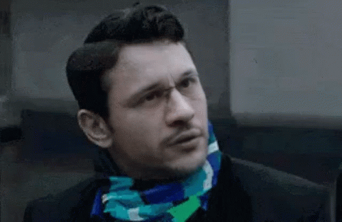 Man Wearing Glasses And Scarf Making Funny Face GIF