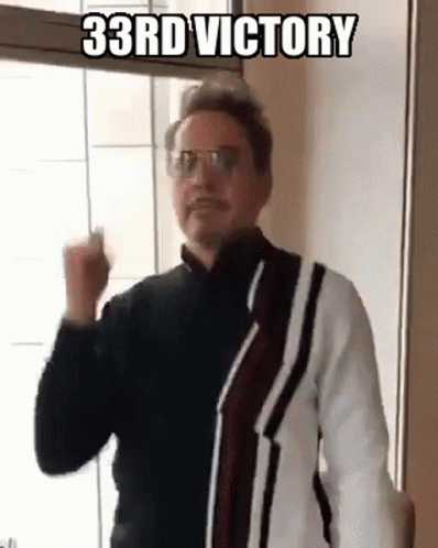 Man Wearing Glasses And Sweater Making Fist GIF