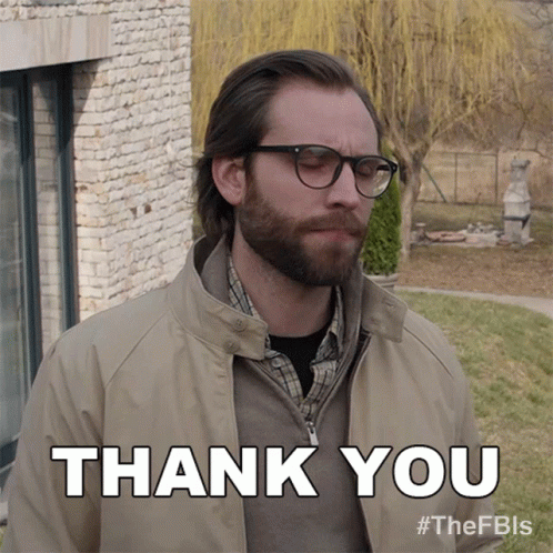 Man Wearing Glasses and Tan Jacket Saying Thank You