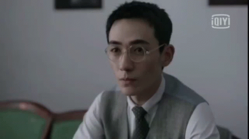 Man Wearing Glasses And Vest Sitting GIF