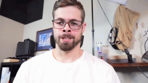 Man Wearing Glasses and White Shirt Making a Face