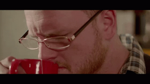 Man Wearing Glasses Drinking Coffee