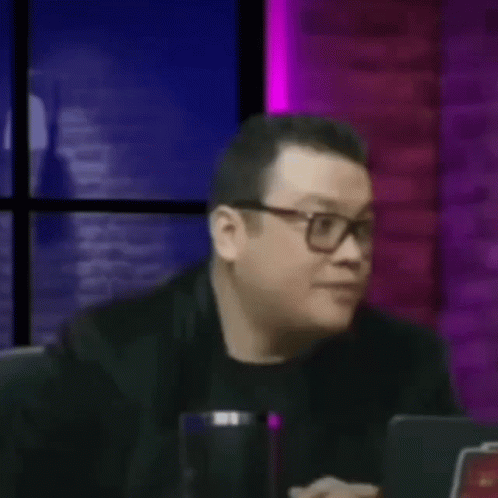 Man Wearing Glasses Hands On Face At Table GIF