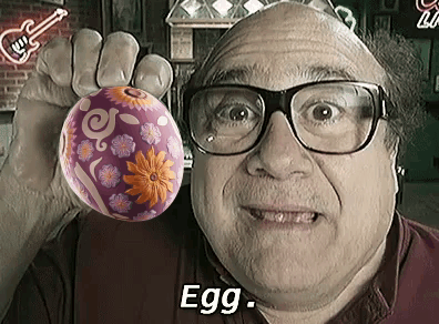 Man Wearing Glasses Holding Purple Easter Egg
