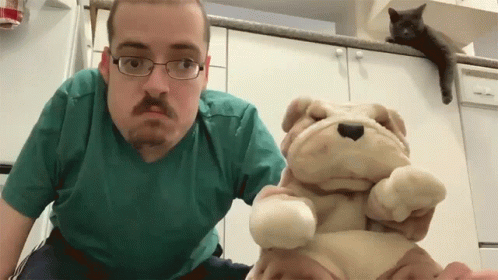 Man Wearing Glasses Holding Stuffed Dog