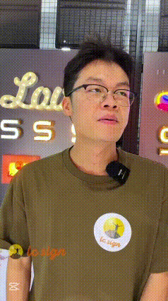 Man Wearing Glasses in Front of Lou Sign