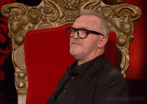 Man Wearing Glasses in Red Chair