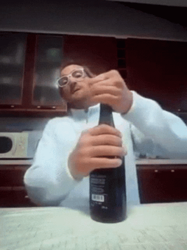 Man Wearing Glasses Opening Bottle GIF