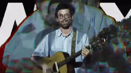 Man Wearing Glasses Playing Guitar