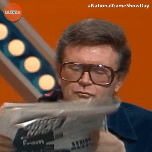 Man Wearing Glasses Reading Newspaper With Buzzr Logo GIF