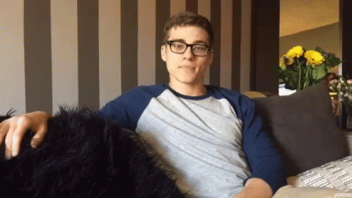 Man Wearing Glasses Sitting On Couch GIF