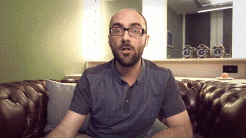 Man Wearing Glasses Sitting on Couch