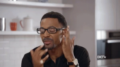 Man Wearing Glasses Touching Face