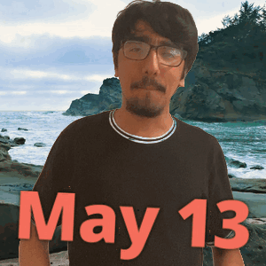 Man Wearing Glasses With May 13 Shirt GIF