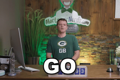 Man Wearing Green Bay Packers Shirt With Mort Nerds.com Sign GIF