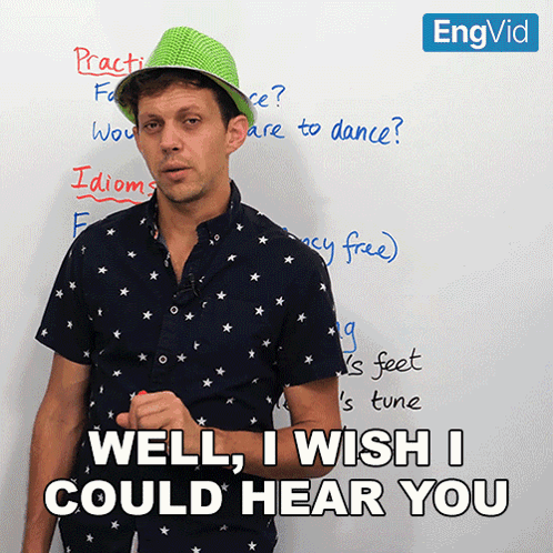 Man Wearing Green Hat in Front of White Board With Well I Wish I Could Hear You