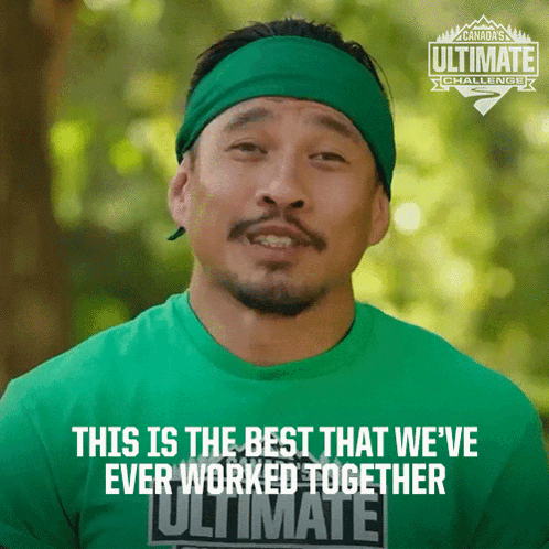 Man Wearing Green Shirt That Says Ultimate