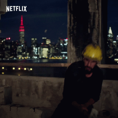 Man Wearing Hard Hat in Front of Netflix Ad