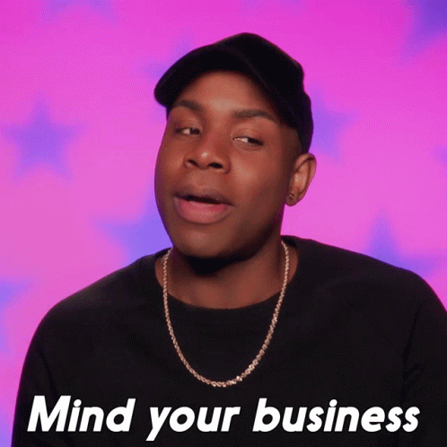 Man Wearing Hat and Necklace Saying Mind Your Business