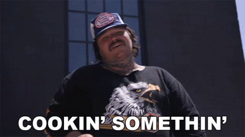Man Wearing Hat and Shirt Saying Cookin Somethin