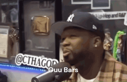 Man Wearing Hat Talking Into Microphone GIF