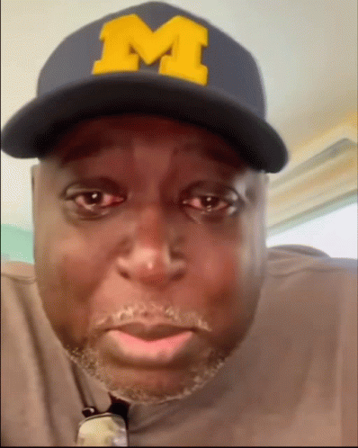 Man Wearing Hat With Yellow M