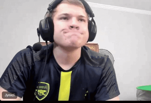 Man Wearing Headphones and Arsenal Shirt